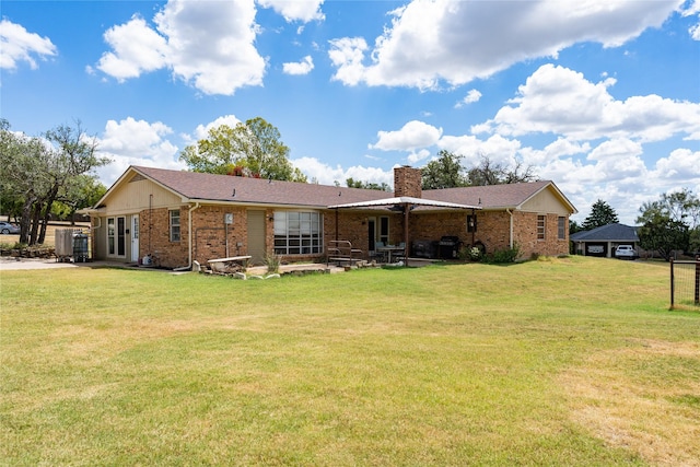 rear view of property featuring a lawn