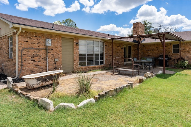 back of house featuring a patio area and a yard