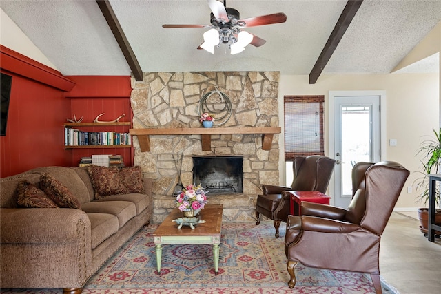 living room featuring a textured ceiling, vaulted ceiling with beams, a stone fireplace, and ceiling fan