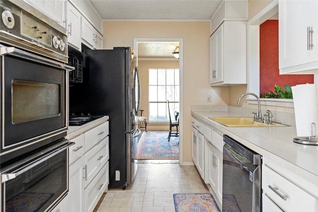 kitchen featuring white cabinets, dishwasher, stainless steel fridge, and sink