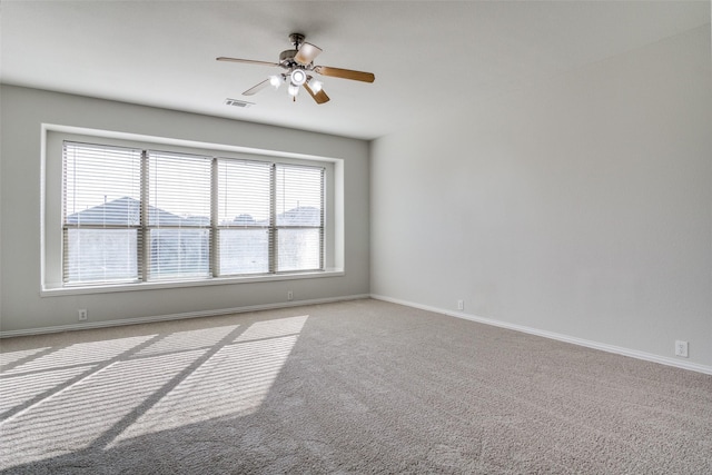 empty room featuring ceiling fan and light colored carpet