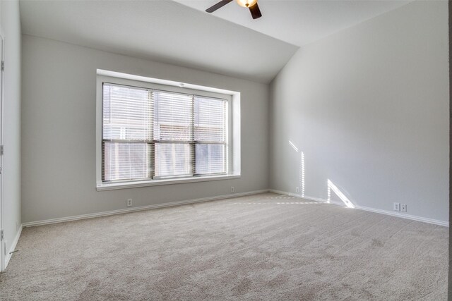 empty room featuring light carpet, ceiling fan, and lofted ceiling