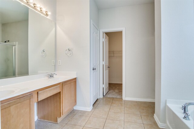 bathroom featuring tile patterned floors, vanity, and shower with separate bathtub