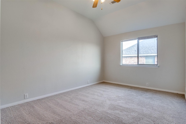 spare room with carpet flooring, ceiling fan, and vaulted ceiling