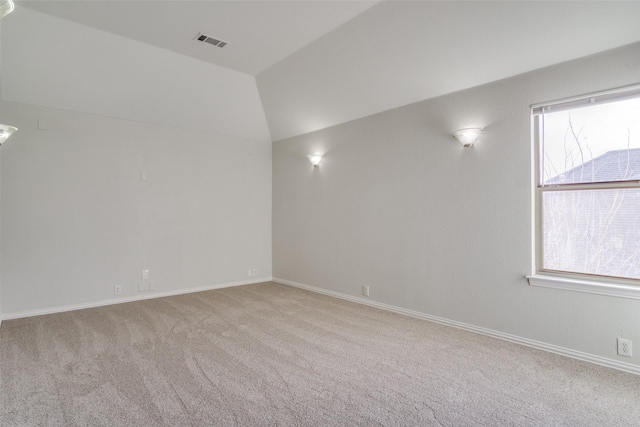 carpeted spare room with lofted ceiling and a wealth of natural light