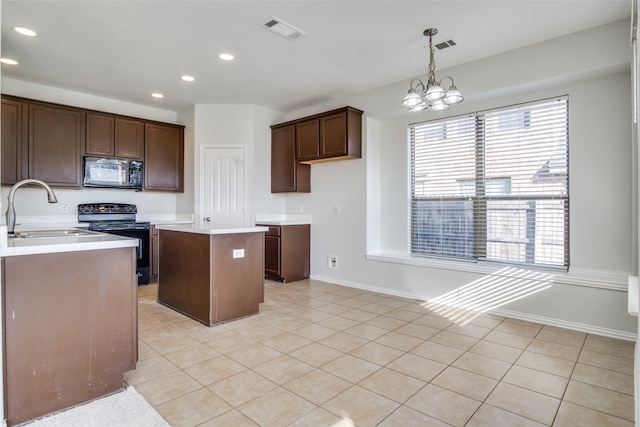 kitchen featuring sink, a notable chandelier, decorative light fixtures, a kitchen island, and black appliances