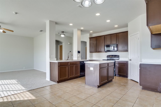 kitchen featuring black appliances, sink, ceiling fan, dark brown cabinets, and kitchen peninsula