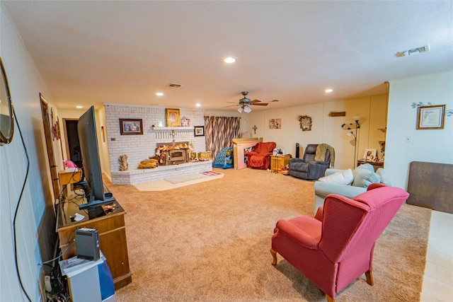 carpeted living room with ceiling fan and a wood stove