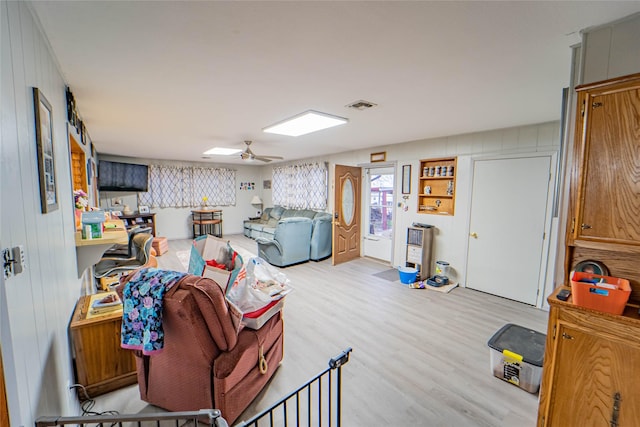 living room featuring ceiling fan and light hardwood / wood-style floors