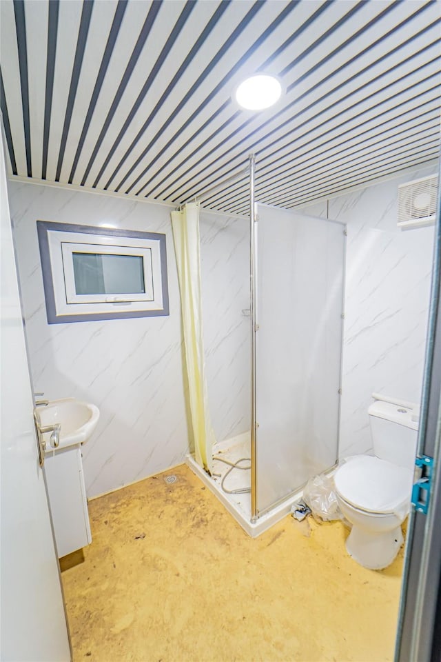 bathroom with vanity, a shower with door, concrete floors, and toilet