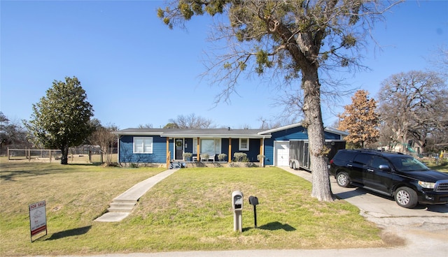 ranch-style home featuring covered porch and a front lawn