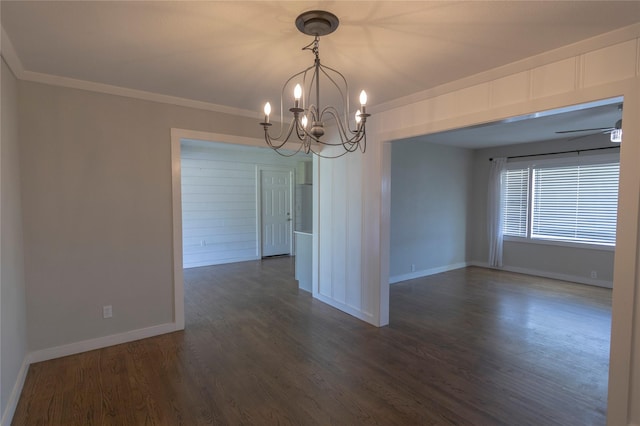 empty room featuring ceiling fan with notable chandelier, crown molding, and dark hardwood / wood-style flooring