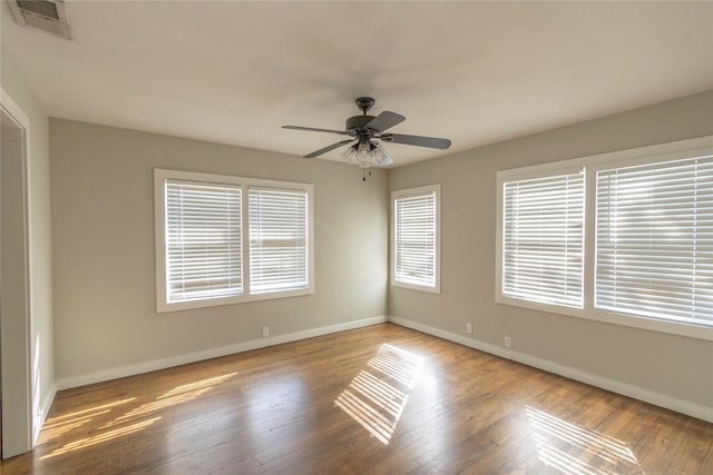 spare room featuring ceiling fan and light hardwood / wood-style flooring