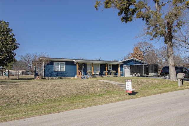 single story home with a garage, covered porch, and a front lawn