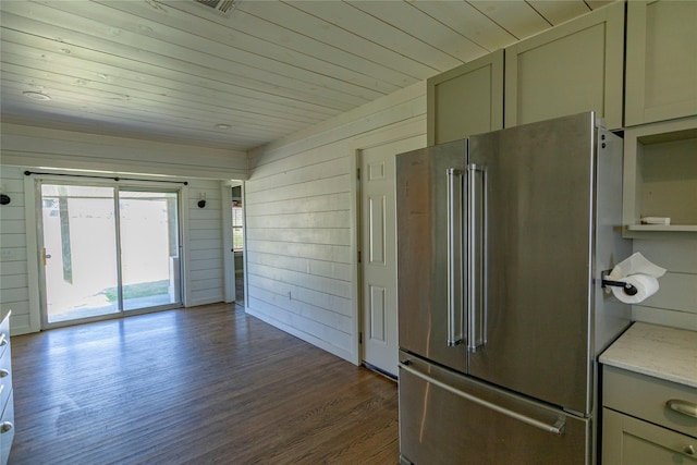 kitchen featuring high quality fridge, wooden walls, wood ceiling, and dark hardwood / wood-style floors