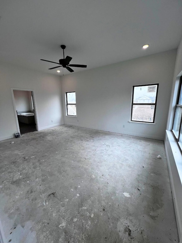 empty room with concrete flooring and ceiling fan