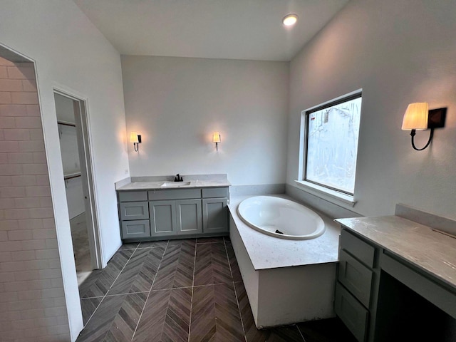 bathroom featuring vanity and a washtub