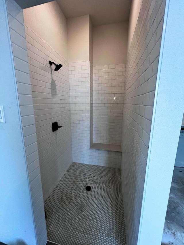 bathroom with a tile shower