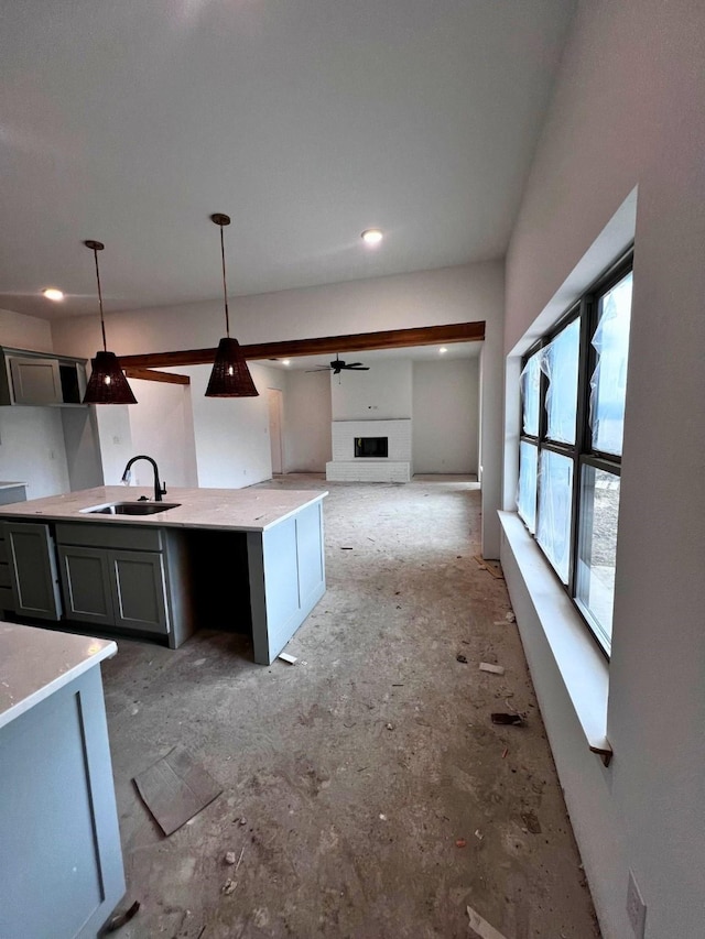 kitchen featuring pendant lighting, sink, and gray cabinets