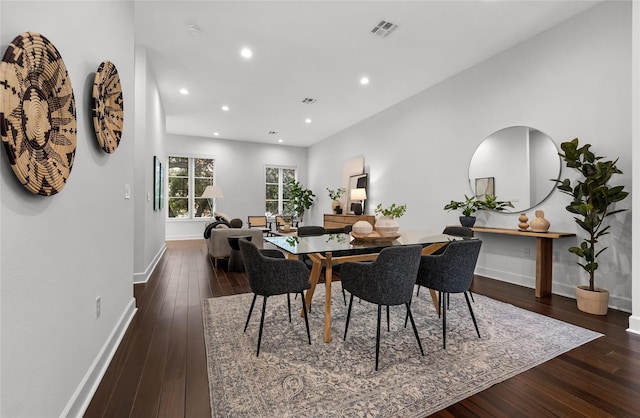 dining space featuring dark wood-type flooring