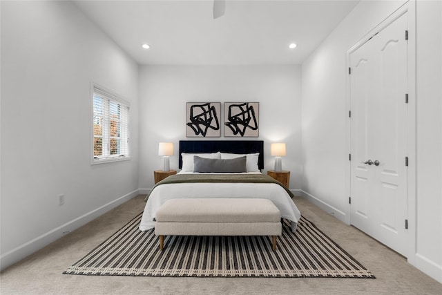 bedroom with ceiling fan and light carpet