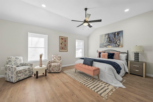 bedroom with ceiling fan, vaulted ceiling, and light wood-type flooring