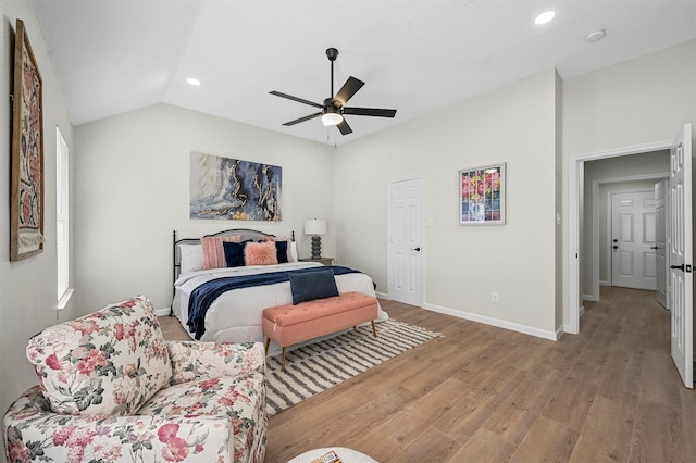 bedroom featuring ceiling fan, light hardwood / wood-style floors, and vaulted ceiling