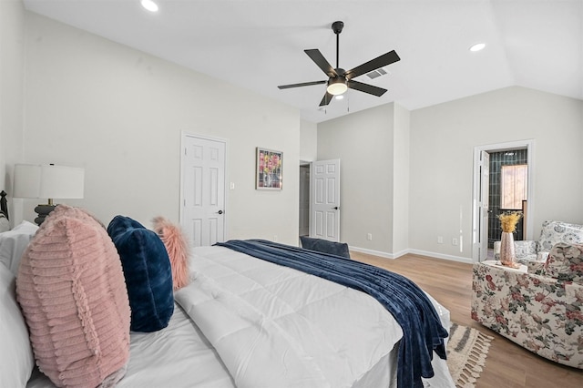 bedroom featuring light hardwood / wood-style flooring, vaulted ceiling, and ceiling fan