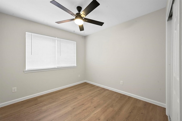 spare room featuring light hardwood / wood-style floors and ceiling fan