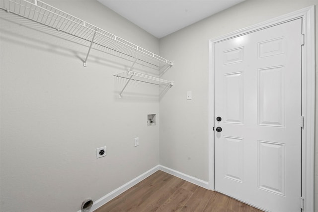 washroom featuring washer hookup, electric dryer hookup, and dark wood-type flooring