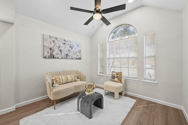 sitting room with ceiling fan, dark hardwood / wood-style flooring, and lofted ceiling