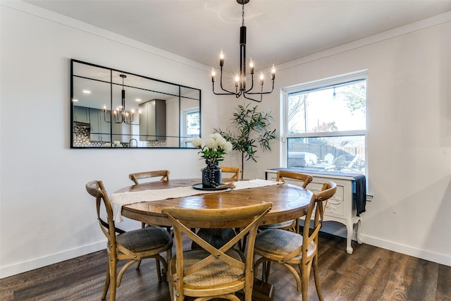 dining room with dark hardwood / wood-style floors, an inviting chandelier, and ornamental molding