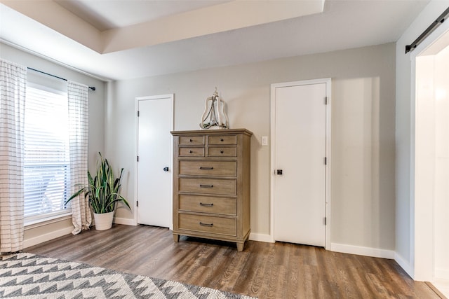 sitting room with dark hardwood / wood-style flooring and a barn door