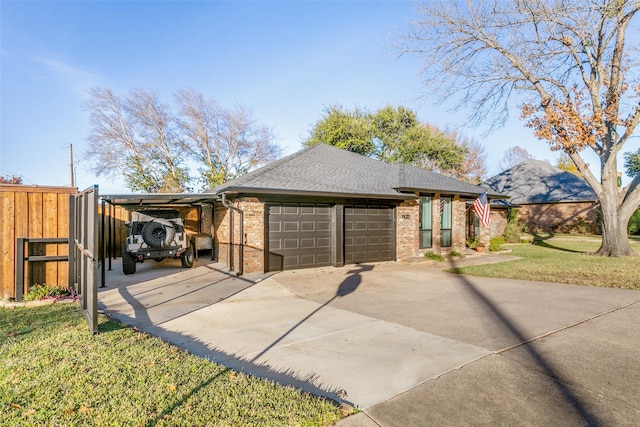 view of front facade with a front lawn, a garage, and a carport