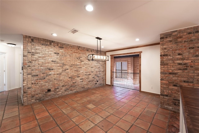 unfurnished dining area featuring ornamental molding and brick wall