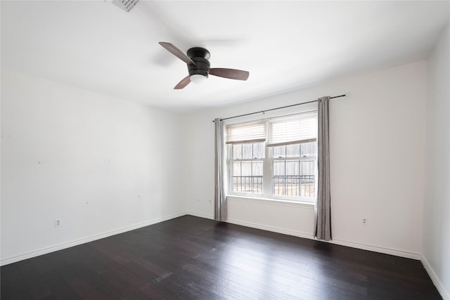 spare room with ceiling fan and dark wood-type flooring