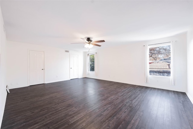 empty room with dark hardwood / wood-style floors and ceiling fan