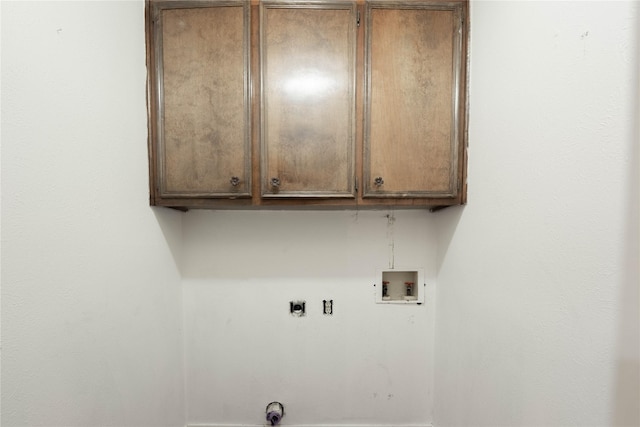 washroom featuring hookup for an electric dryer, cabinets, and washer hookup