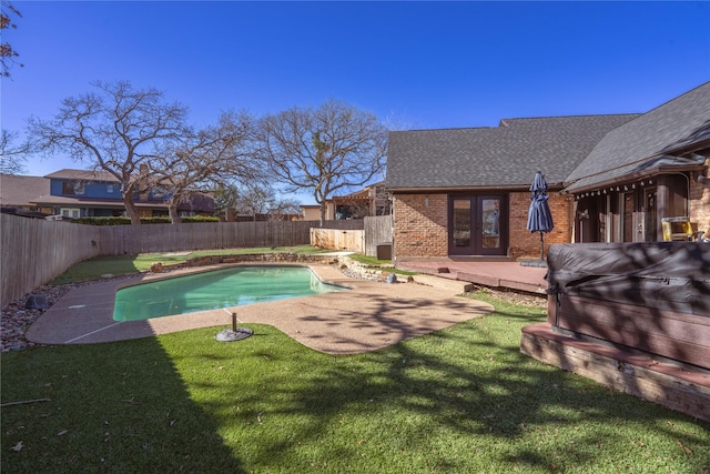 view of swimming pool with french doors, a lawn, a patio area, and a wooden deck