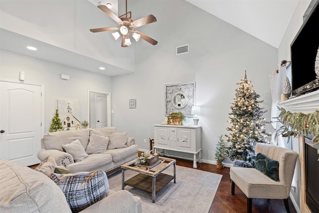 living room with dark hardwood / wood-style floors, high vaulted ceiling, and ceiling fan