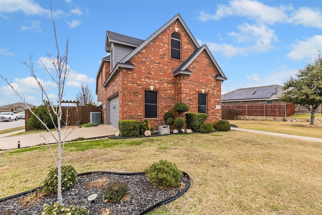 view of front property with central AC unit, a garage, and a front lawn