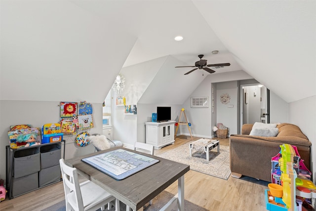 rec room with ceiling fan, lofted ceiling, and light wood-type flooring