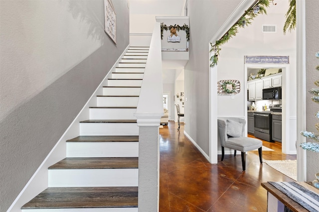 stairs with concrete flooring