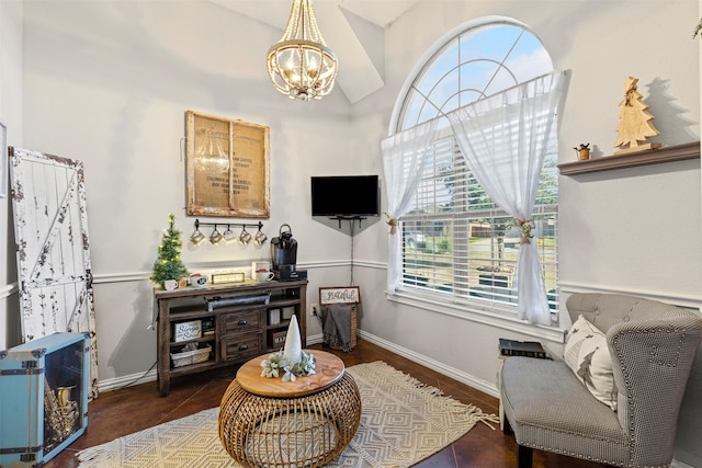 living area with dark hardwood / wood-style flooring and an inviting chandelier