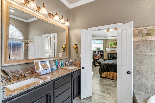 bathroom featuring crown molding, plenty of natural light, and vanity