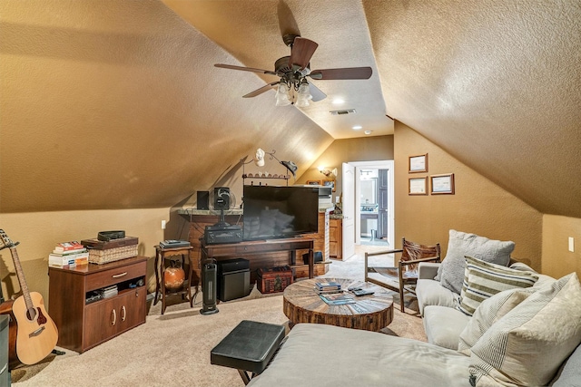 carpeted living room featuring lofted ceiling, ceiling fan, and a textured ceiling