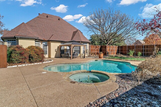 view of pool featuring a gazebo, an in ground hot tub, and a patio