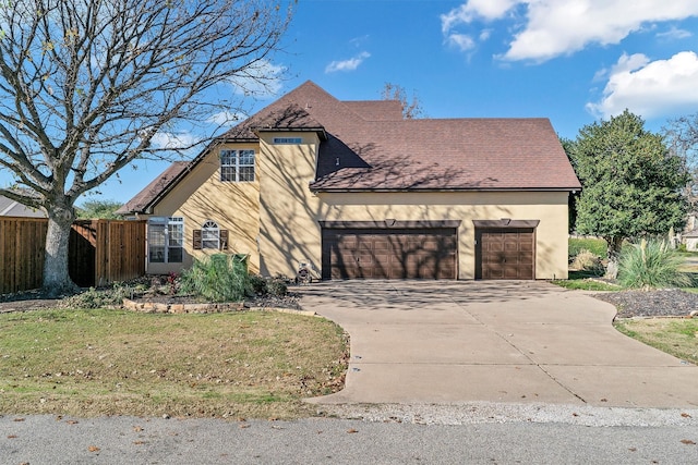 view of front facade with a garage and a front yard