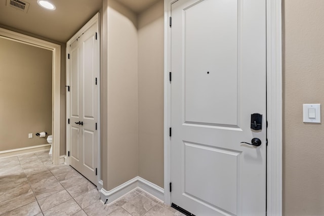 doorway to outside featuring light tile patterned flooring