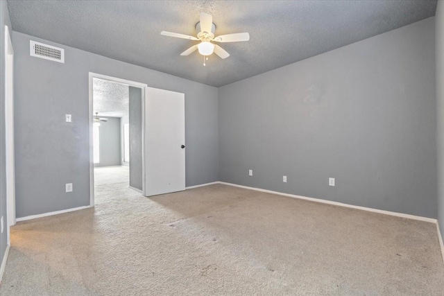 carpeted empty room featuring a textured ceiling and ceiling fan